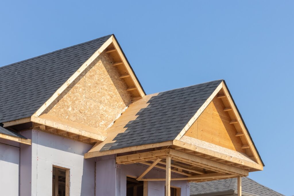 Dormers of a residential construction project showing plywood roof and oriented strand board or chip board dormer sheathing