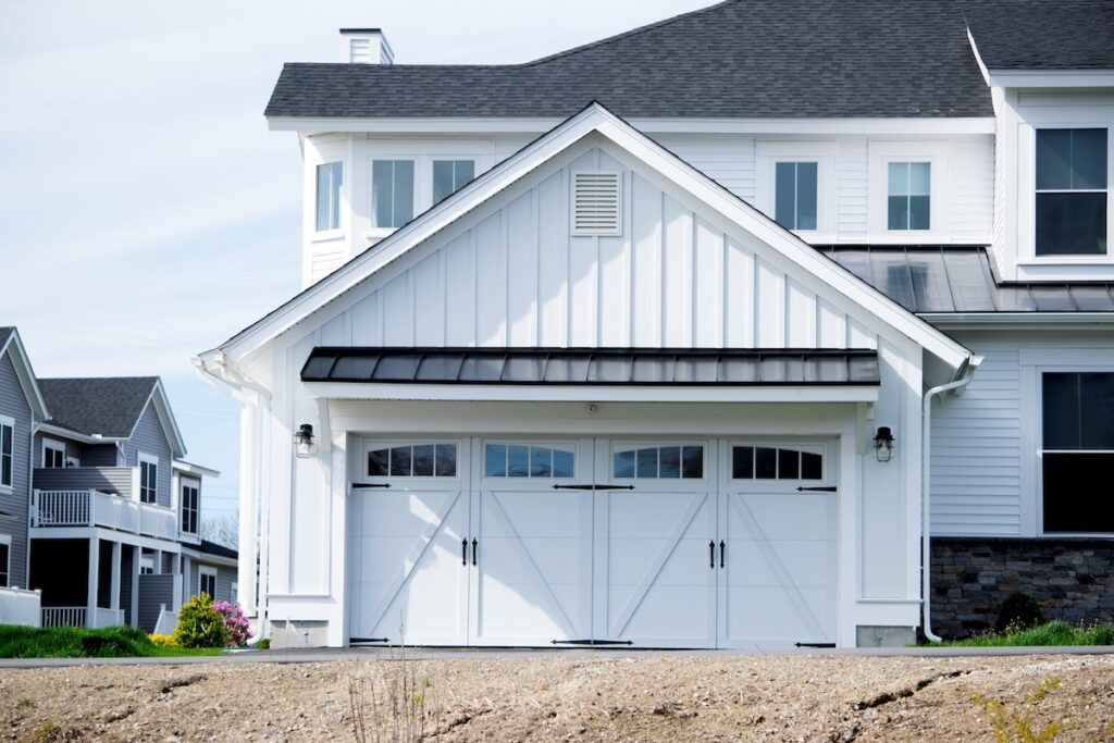 Two cars Garage Door painted in white color in a typical single house.
