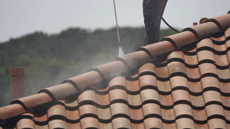 Pressure-washing a roof, medium close up of high power spray