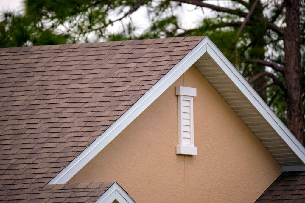 Closeup of house roof top covered with asphalt shingles