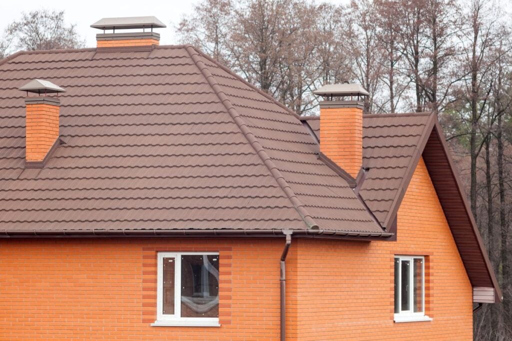 brick house with stone coated metal roof