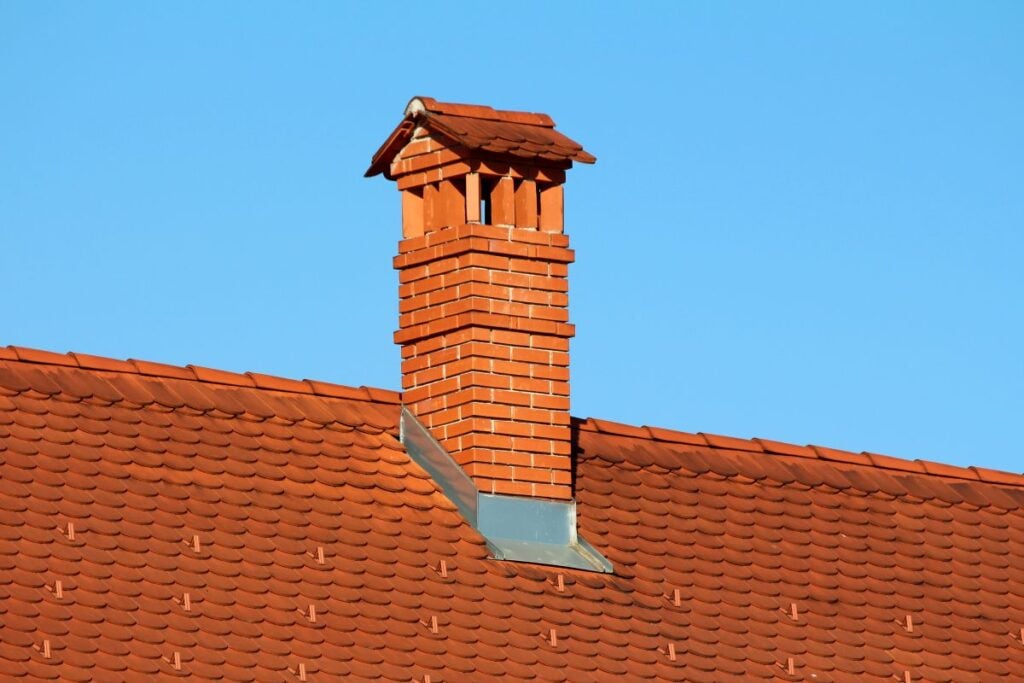 brick chimney with flashing on a tile roof