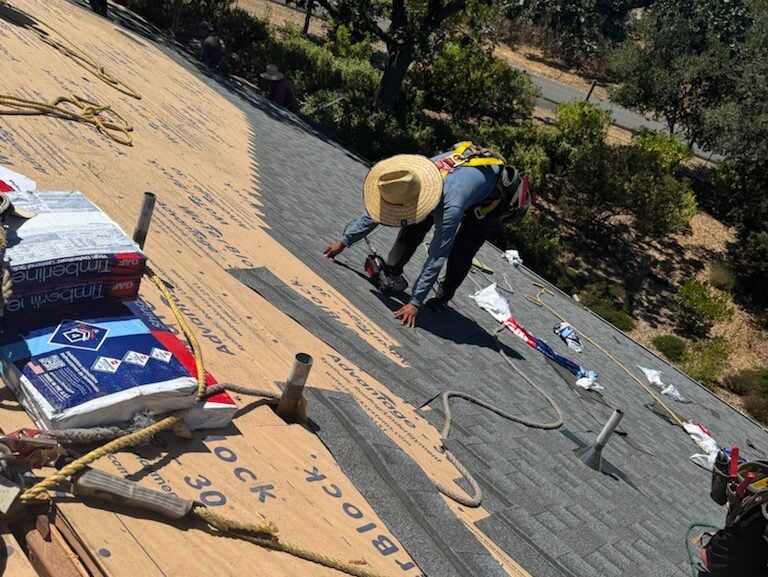 how to fix a sagging roof Capstone roofing worker replacing shingles