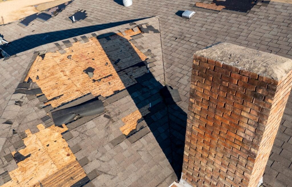 how to file a roof insurance claim grey shingles missing brick wall chimney